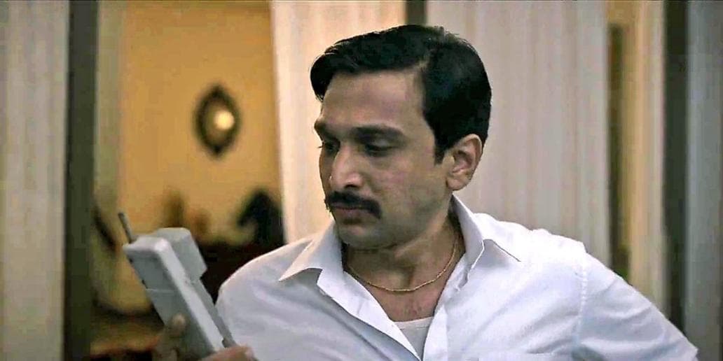 Harshad Mehta looking at phone meme template
